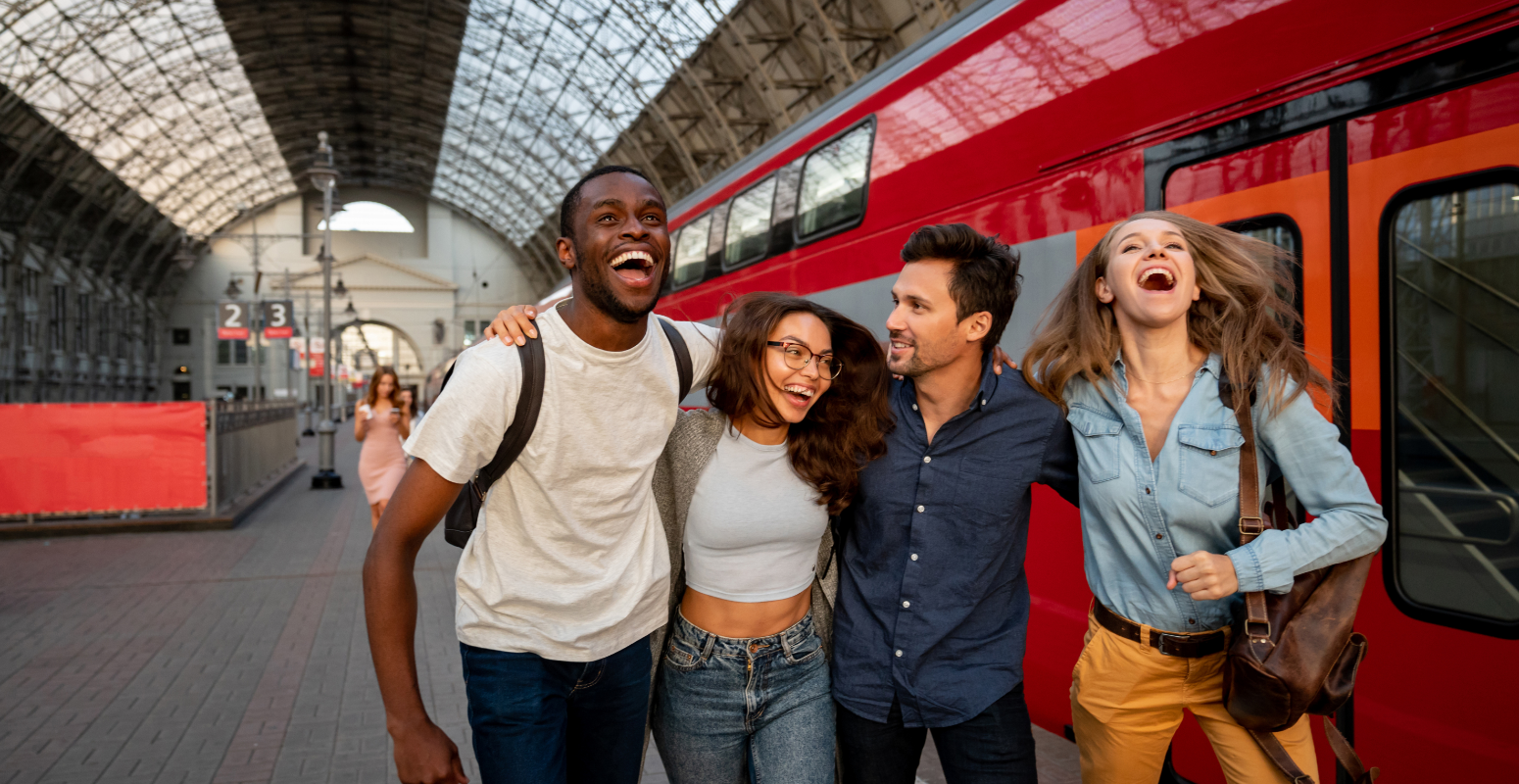 Refer-a-friend success. Friends laughing together at the train station